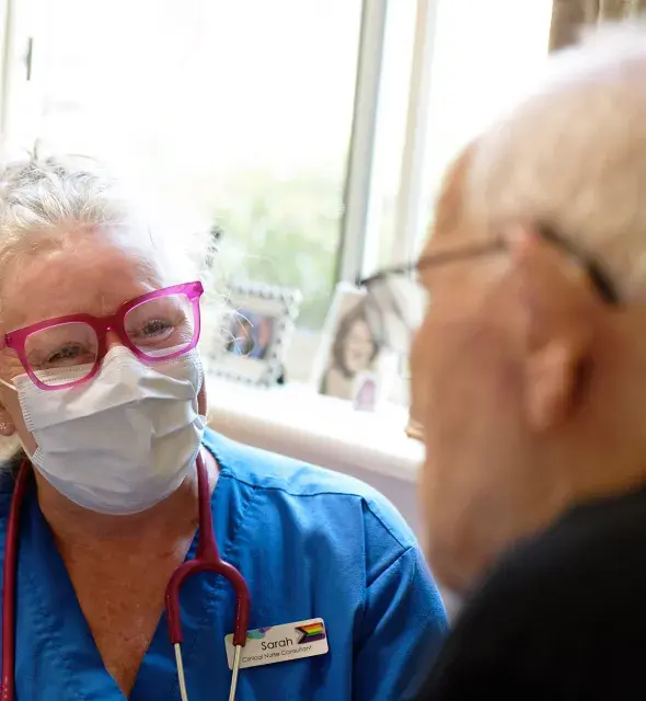 Western health staff smiling with a elderly consumer 
